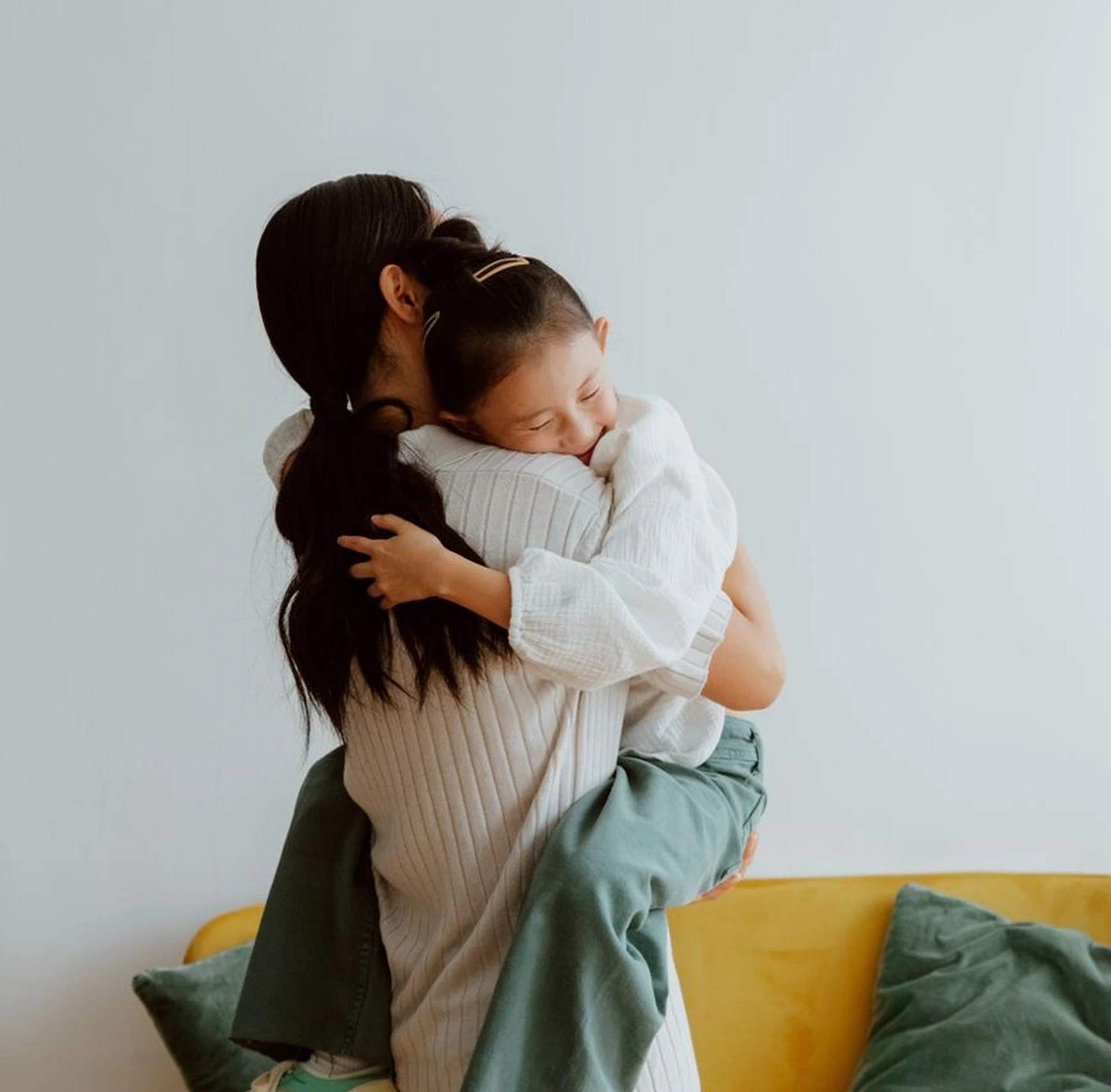 A carer holding and comforting a young child